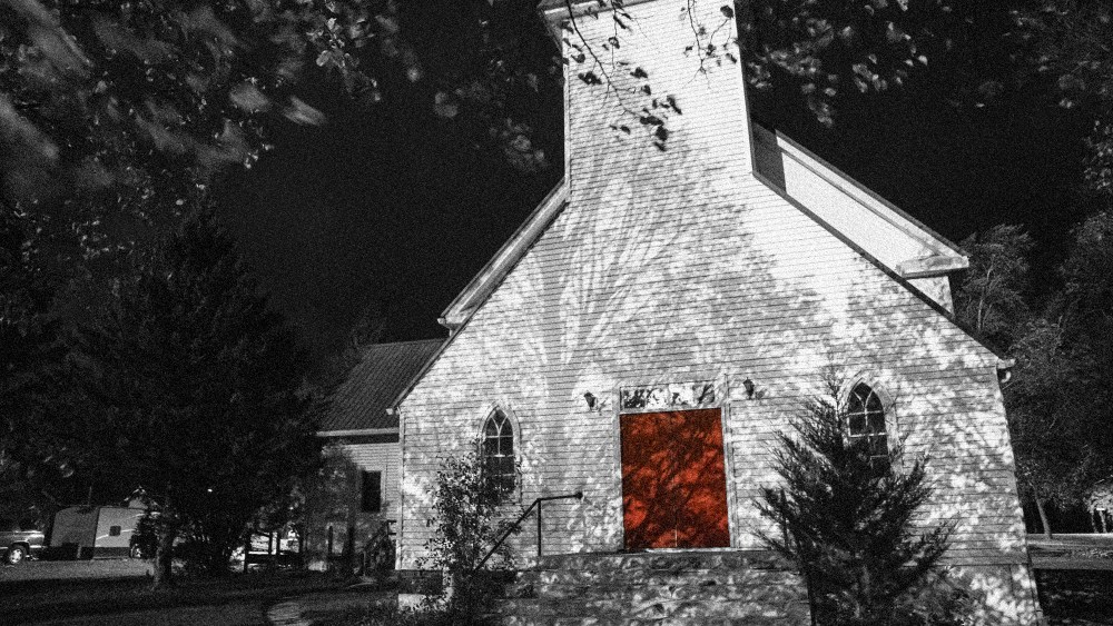 Image: A white church with a red door