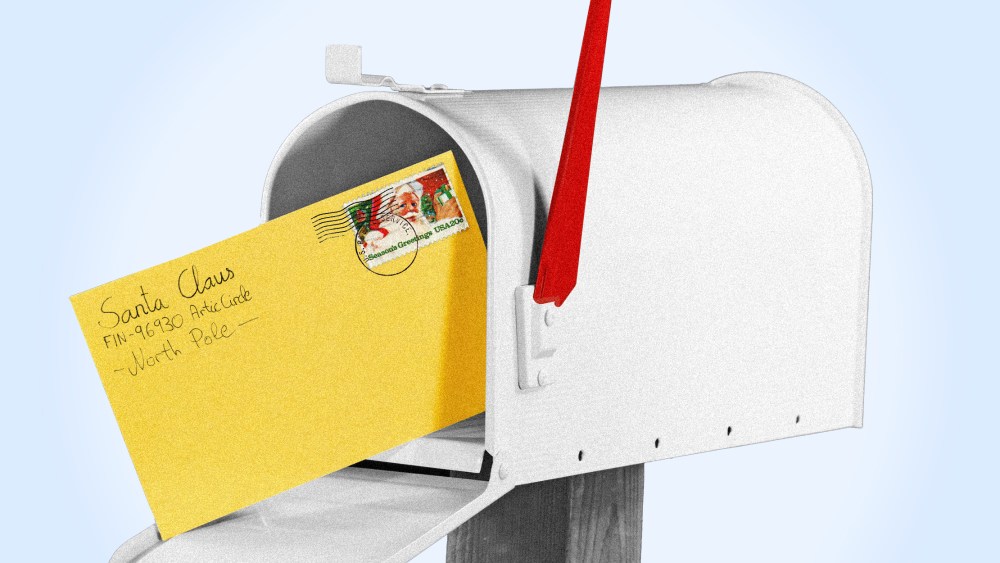 Image: An open mailbox with a yellow later from Santa Claus.