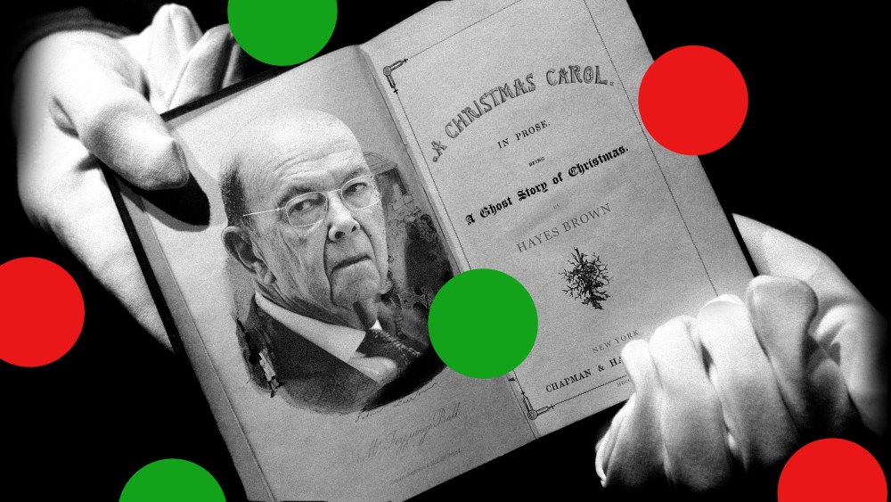 Image: A hand holding an open copy of 'The Christmas Carol' with a photo of Wilbur Ross on the page.