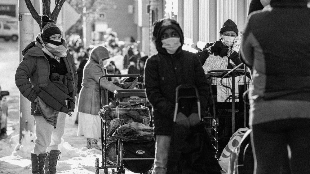 Image: People wait in line at a food pantry in Everett, Mass., on Dec. 19, 2020.