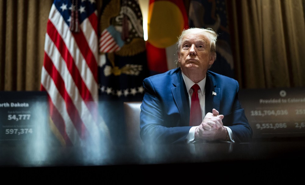 Image: President Donald Trump looks on he as meets with Colorado Governor Jared Polis and North Dakota Governor Doug Burgum in the Cabinet Room of the White House
