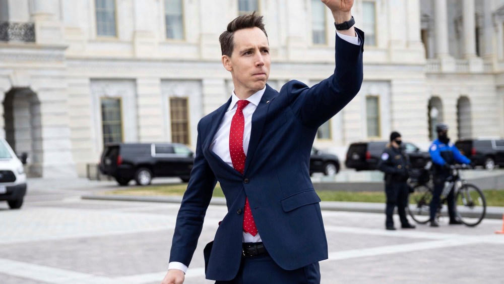 Image: Sen. Josh Hawley, R-Mo. raises his fist toward a crowd of supporters of President Donald Trump gathered outside the Capitol