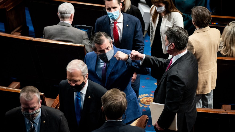 Image: Ted Cruz fist bumps with a house member followed by Josh Hawley.