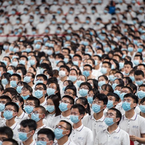 Image: Rows of students wearing masks at commencement ceremony at Wuhan University.