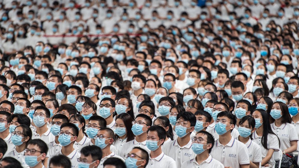 Image: Rows of students wearing masks at commencement ceremony at Wuhan University.