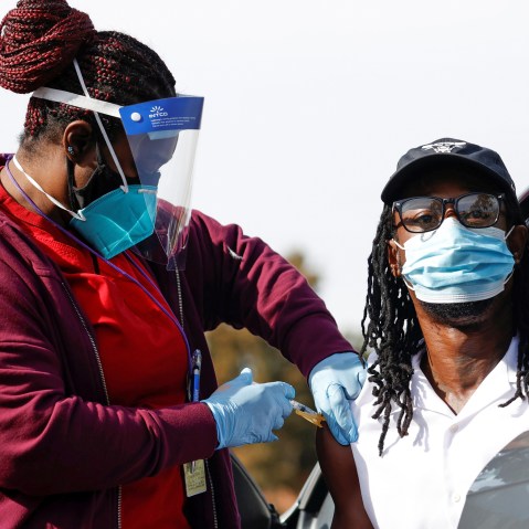 Image: Nurse Dawn Duran administers a dose of the Moderna COVID-19 vaccine to Jeremy Coran during the outbreak of the coronavirus disease (COVID-19), in Pasadena