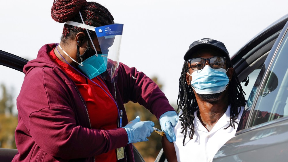 Image: Nurse Dawn Duran administers a dose of the Moderna COVID-19 vaccine to Jeremy Coran during the outbreak of the coronavirus disease (COVID-19), in Pasadena