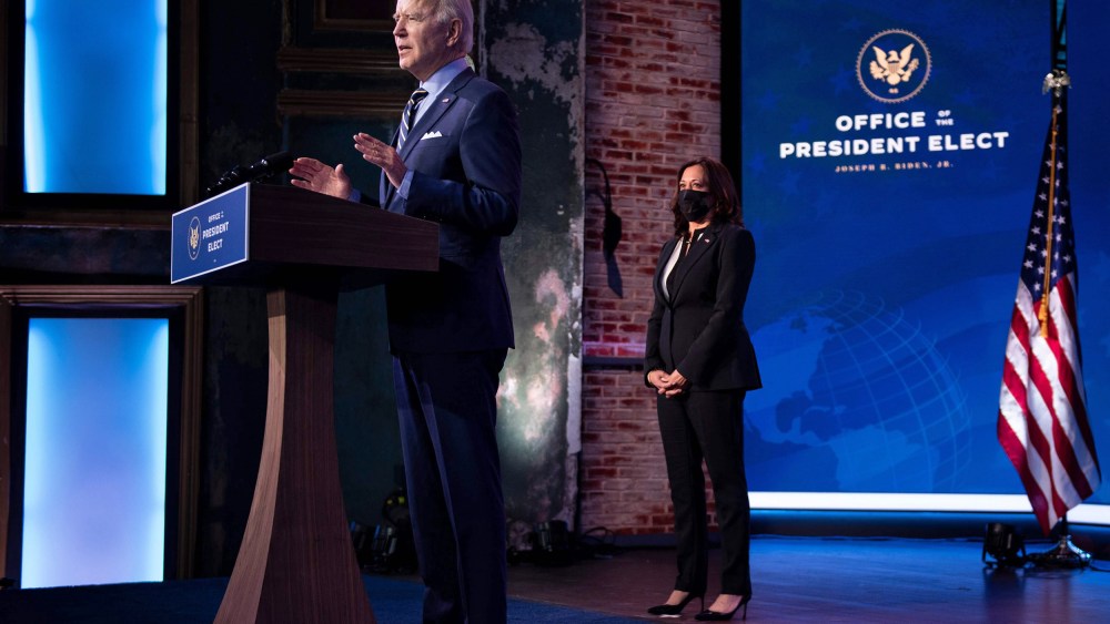 Vice President-elect Kamala Harris listens while as President-elect Joe Biden speaks at the Queen Theater on Dec. 28, 2020, in Wilmington, Del.