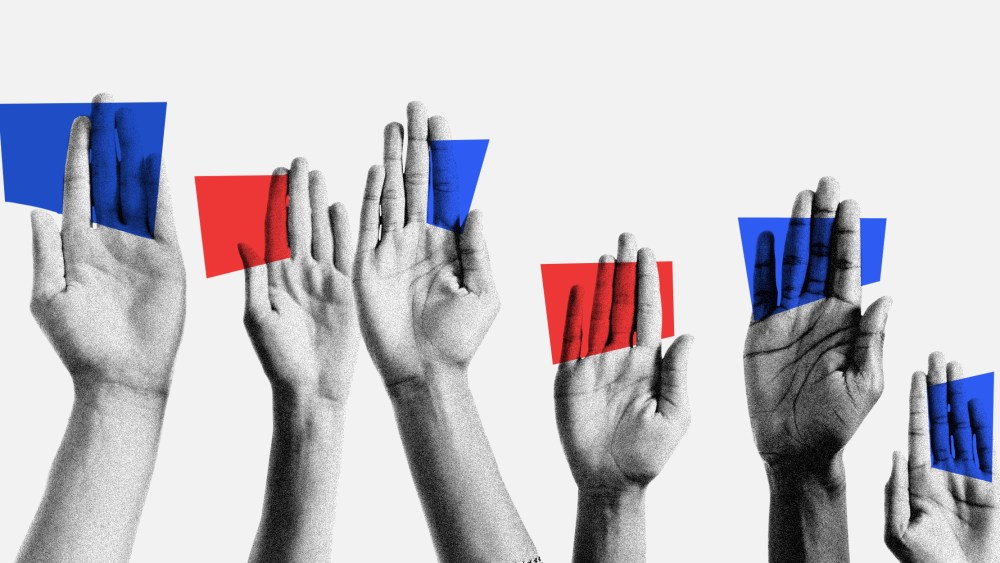 Photo illustration of raised handing holding blue and red cards