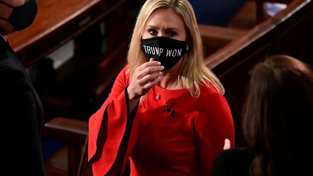 Image: Rep. Marjorie Taylor Greene (R-GA) wears a "Trump Won" face mask as she arrives to take her oath of office as a member of the 117th Congress in Washington