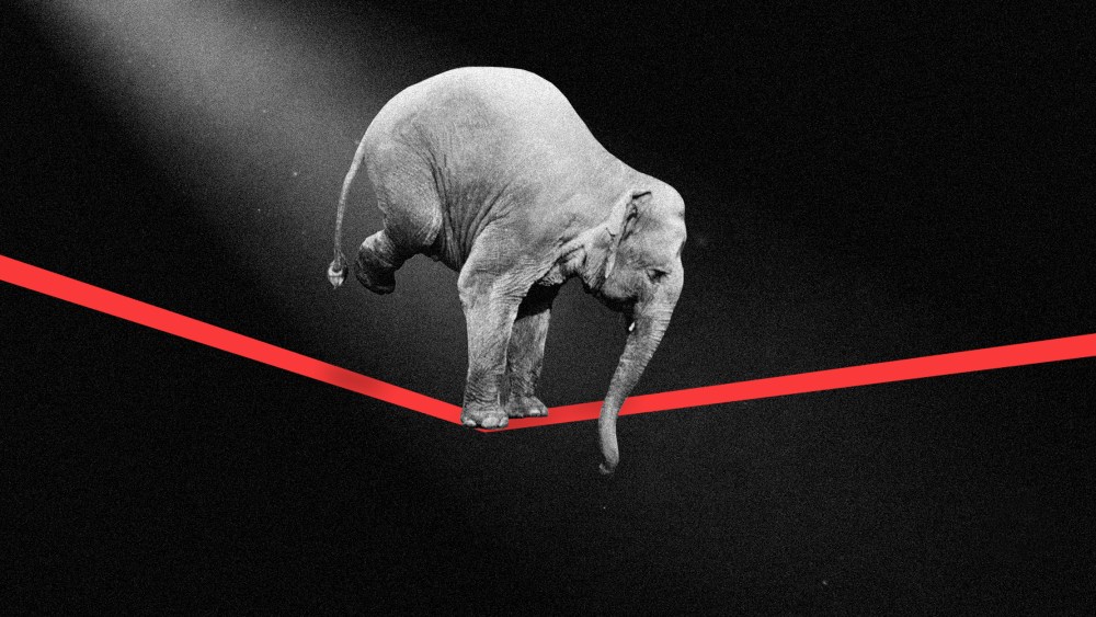 Photo illustration of an elephant in the spotlight walking a across a tight rope.