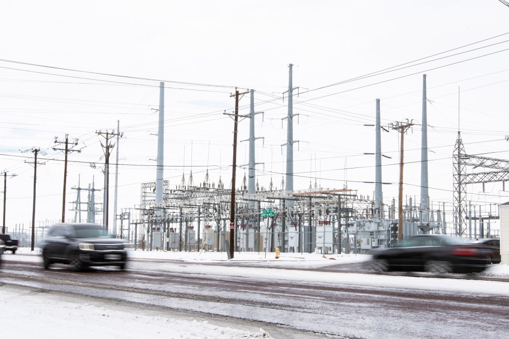 Image: Motorist on County Road West drive past a power station Tuesday, Feb. 16, 2021, in Odessa, Tx.