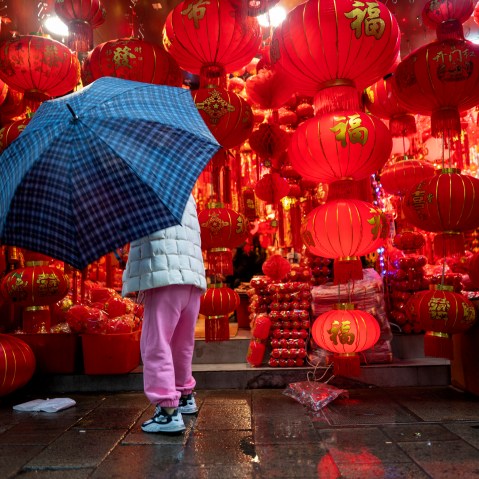 Image; A woman shops for lanterns ahead of Chinese New Year in Shaoxing, China, on Feb. 11, 2021.