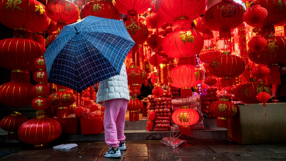 Image; A woman shops for lanterns ahead of Chinese New Year in Shaoxing, China, on Feb. 11, 2021.