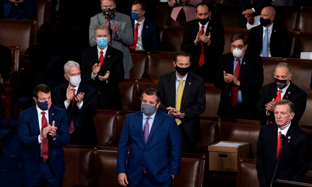 Image: Sen. Ted Cruz and Rep. Paul Gosar are being applauded by Republican colleagues around them.