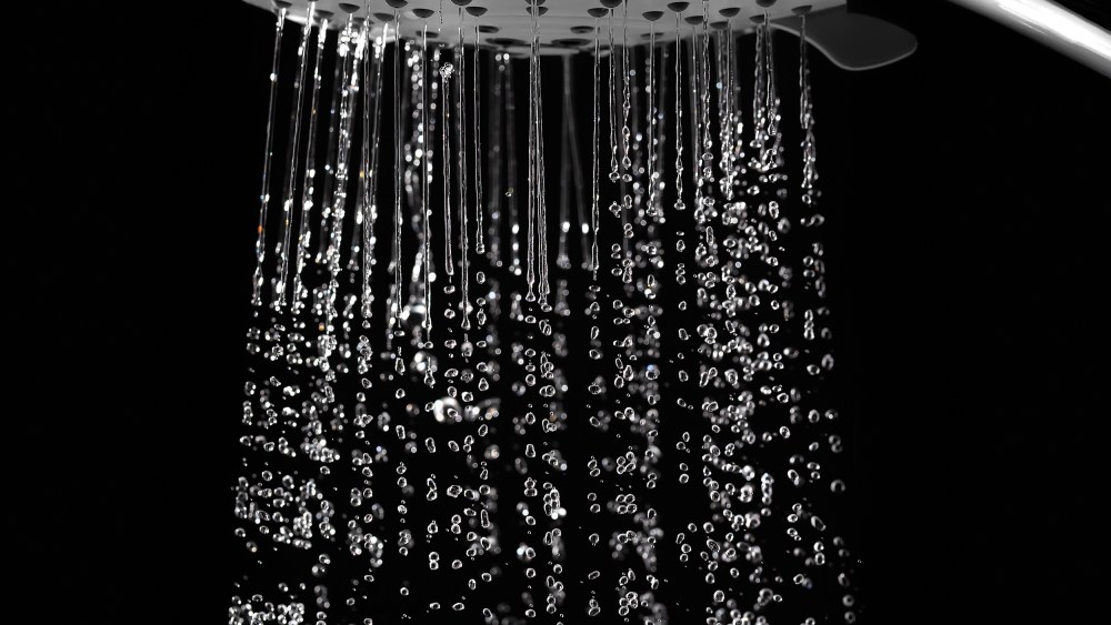 Water jets from the shower on black