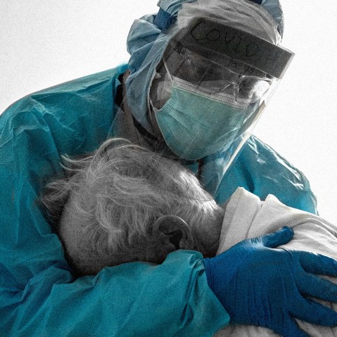 Image: A doctor hugs and comforts a patient in the hospital