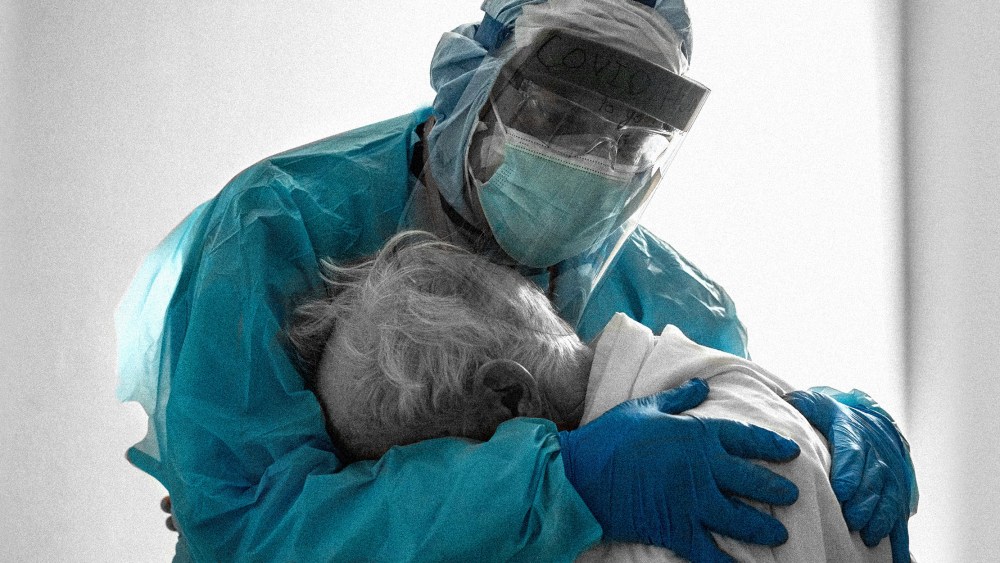 Image: A doctor hugs and comforts a patient in the hospital
