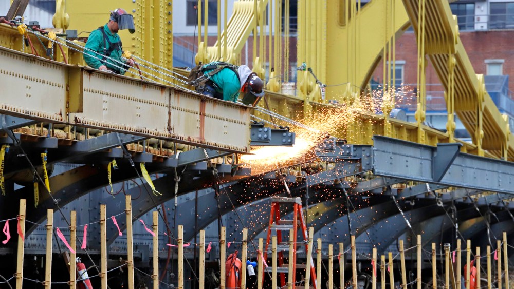 Image: worker welds on the Ninth Street bridge in Pittsburgh
