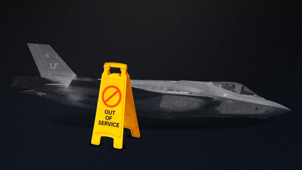 Photo illustration of the F-35 II Lightning aka the Joint Strike Fighter in a dim room next to a yellow sign that reads,"OUT OF ORDER".