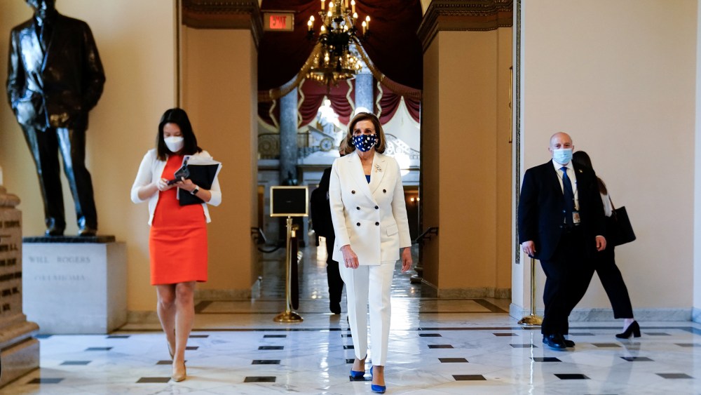 Image: Speaker of the House Pelosi walks to the House floor for the final vote on President Biden's coronavirus (COVID-19) relief bill at the U.S. Capitol in Washington