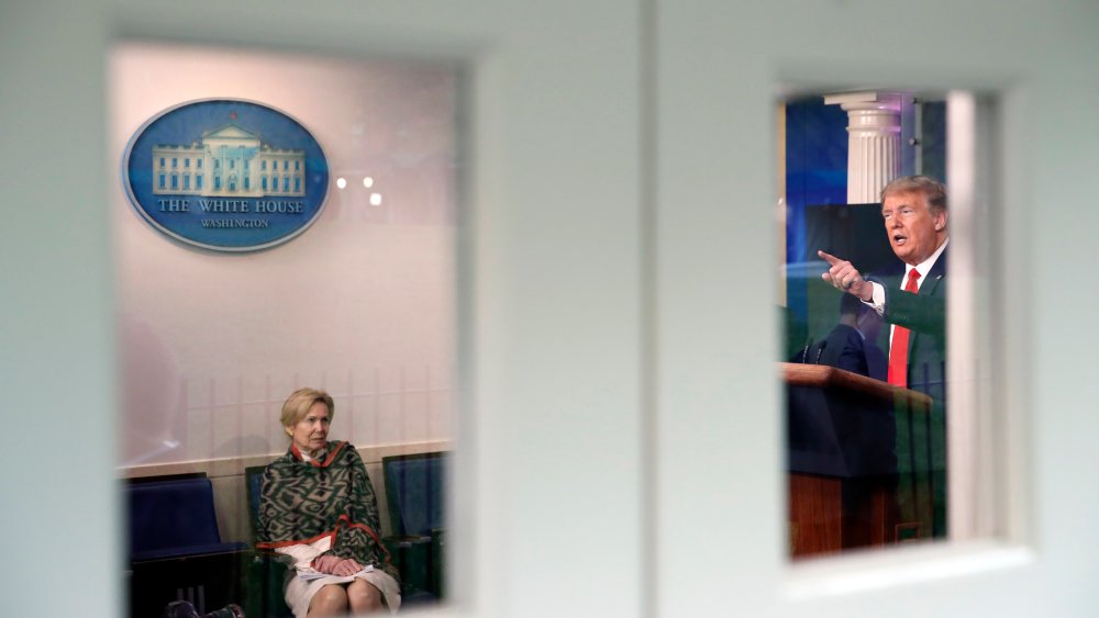 Image: Dr. Deborah Birx listens to President Trump in the White House briefing room.