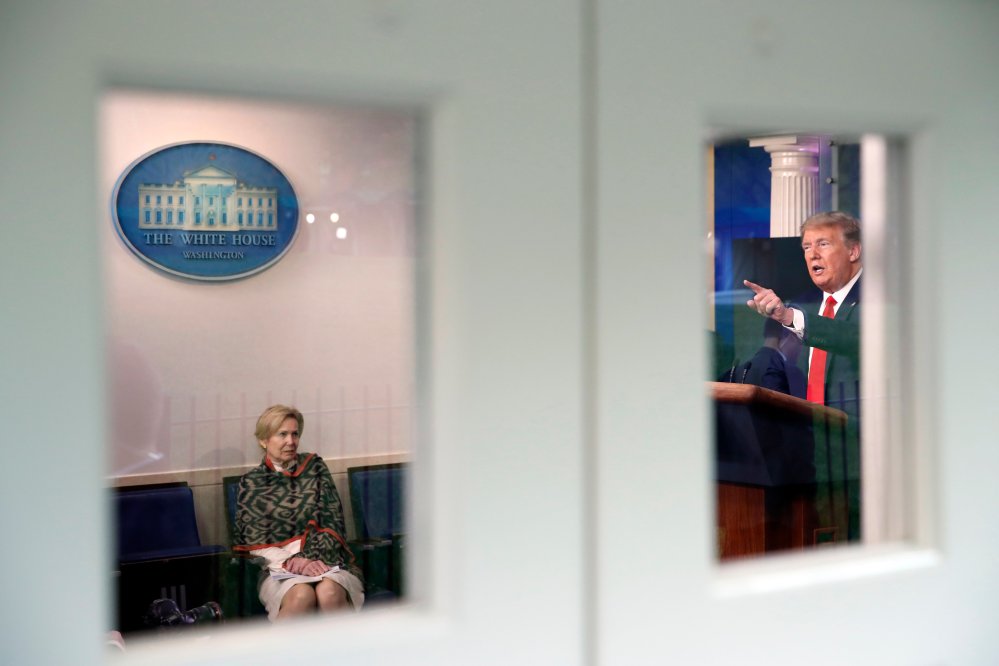 Image: Dr. Deborah Birx listens to President Trump in the White House briefing room.