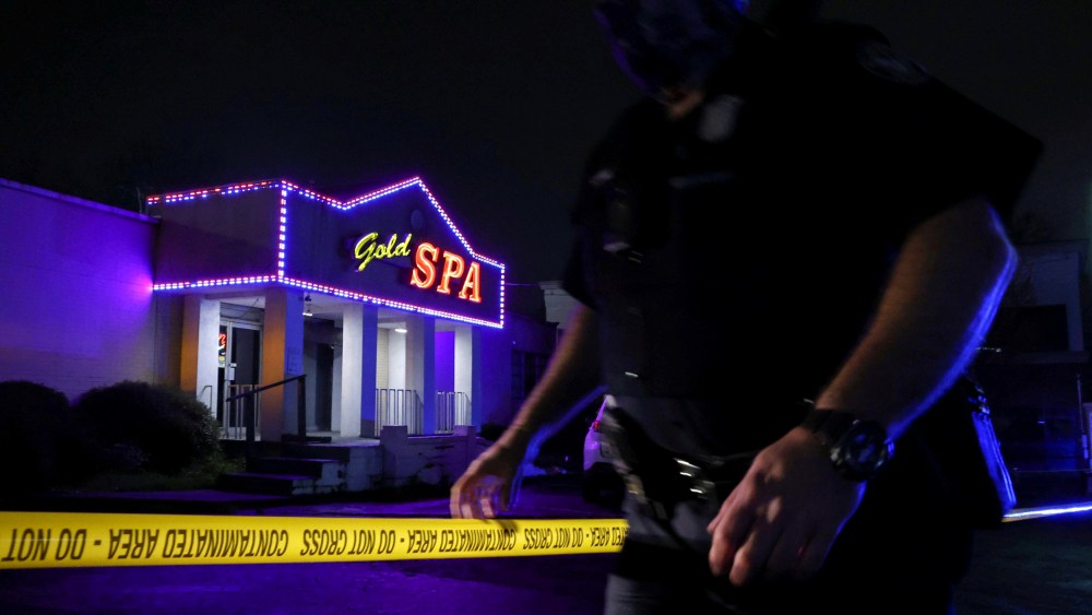 Image: A police officer at the taped scene outside of Gold Spa in Atlanta, Georgia.