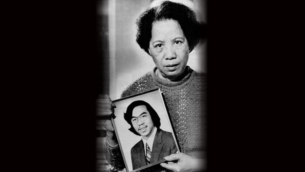 Image: Lily Chin holds a photograph of her son Vincent Chin.