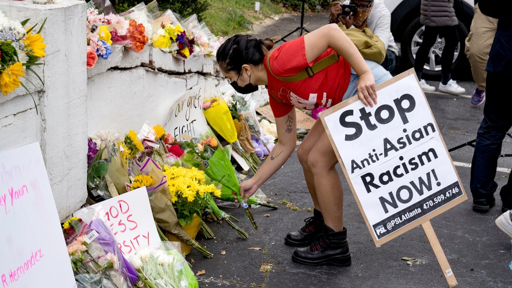 Image: Activists drop flowers during a demonstration against violence against women and Asians following Tuesday night's shooting on March 18, 2021 in Atlanta.