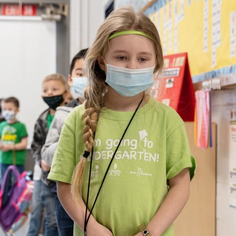 Image: Masked students wait in a socially distanced single file line before heading to the cafeteria at Medora Elementary School on March 17, 2021 in Louisville, Kentucky. Today marks the reopening of Jefferson County Public Schools for in-person learning