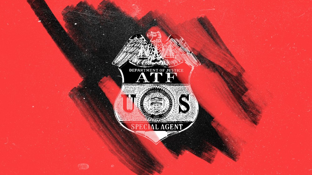 Photo illustration of a red layer being removed off a badge against a black dusty background . The badge reads,"Department of Justice ATP U.S. Special Agent. A seal on it reads, "Bureau of Alcohol, Tobacco, Firearms and Explosives, 1972".