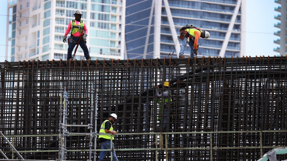 Construction workers build the "Signature Bridge" in Miami on March 17, 2021.