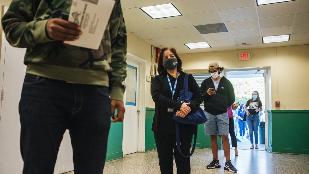 Voters wait in line at a polling location in Miami on Nov. 3, 2020.