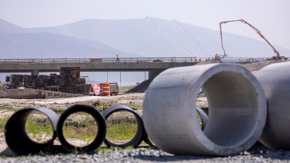 Image: Work crews continue to work on the construction of a freeway overpass in San Diego