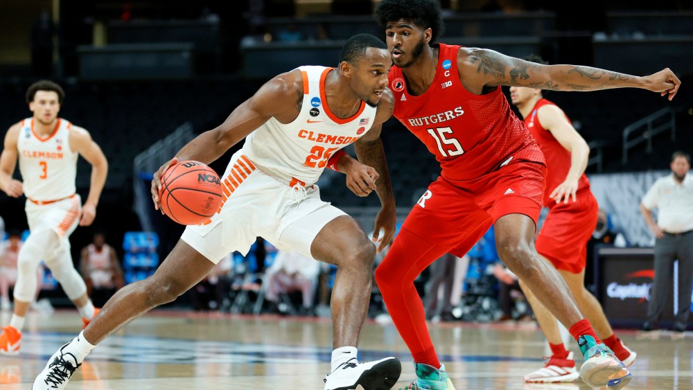 Aamir Simms #25 of the Clemson Tigers handles the ball in the first half against Myles Johnson #15 of the Rutgers Scarlet Knights on March 19, 2021, in Indianapolis.