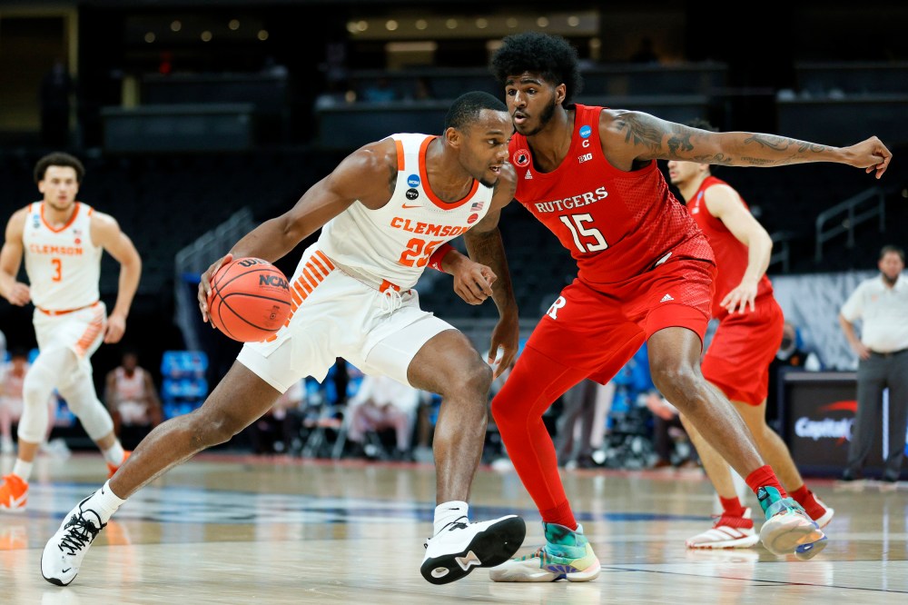 Aamir Simms #25 of the Clemson Tigers handles the ball in the first half against Myles Johnson #15 of the Rutgers Scarlet Knights on March 19, 2021, in Indianapolis.