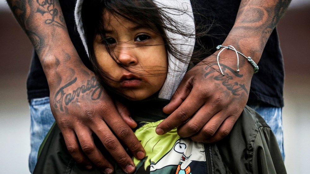 Image: Jose Chavez wraps his arms around his daughter, Cattleya Chavez, 3, at a protest outside the Brooklyn Center Police Department in Minnesota on April 13, 2021.