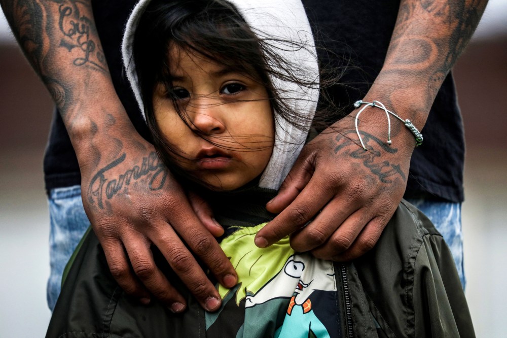Image: Jose Chavez wraps his arms around his daughter, Cattleya Chavez, 3, at a protest outside the Brooklyn Center Police Department in Minnesota on April 13, 2021.