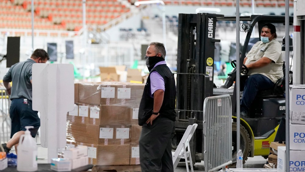 Image: Some of the 2.1 million ballots cast during the 2020 election, are brought in for recounting at a 2020 election ballot audit ordered by the Republican lead Arizona Senate at the Arizona Veterans Memorial Coliseum