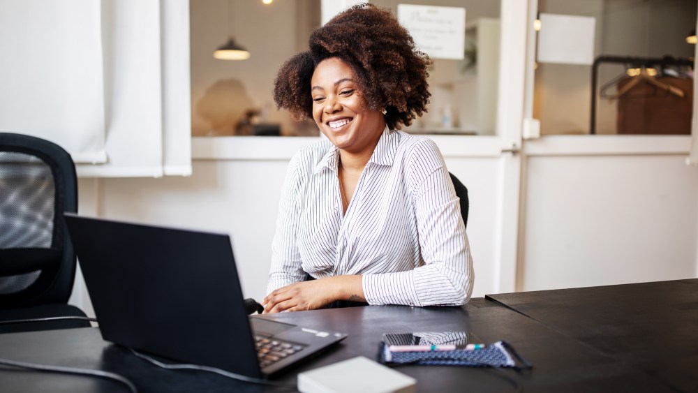 Businessman sitting in office smiling during a video call