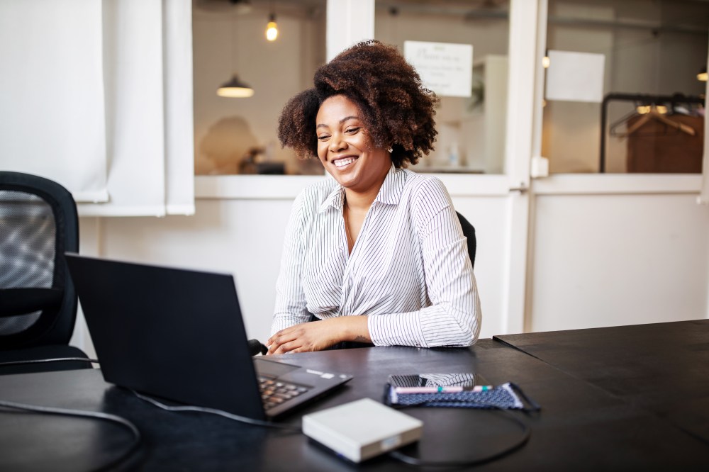 Businessman sitting in office smiling during a video call