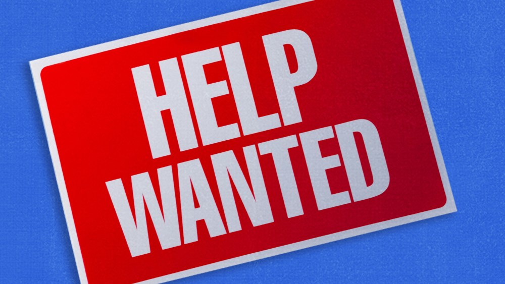 Photo illustration: A titled "Help Wanted" sign on a blue background.
