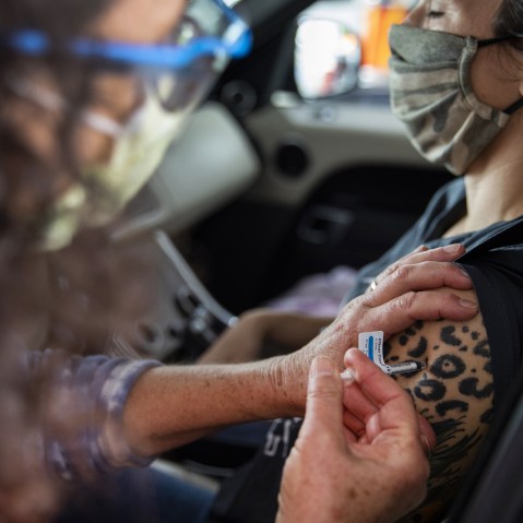 Healthcare Workers Administer Covid-19 Vaccines At Airport As U.S. Daily Cases Hit 14-Month Low