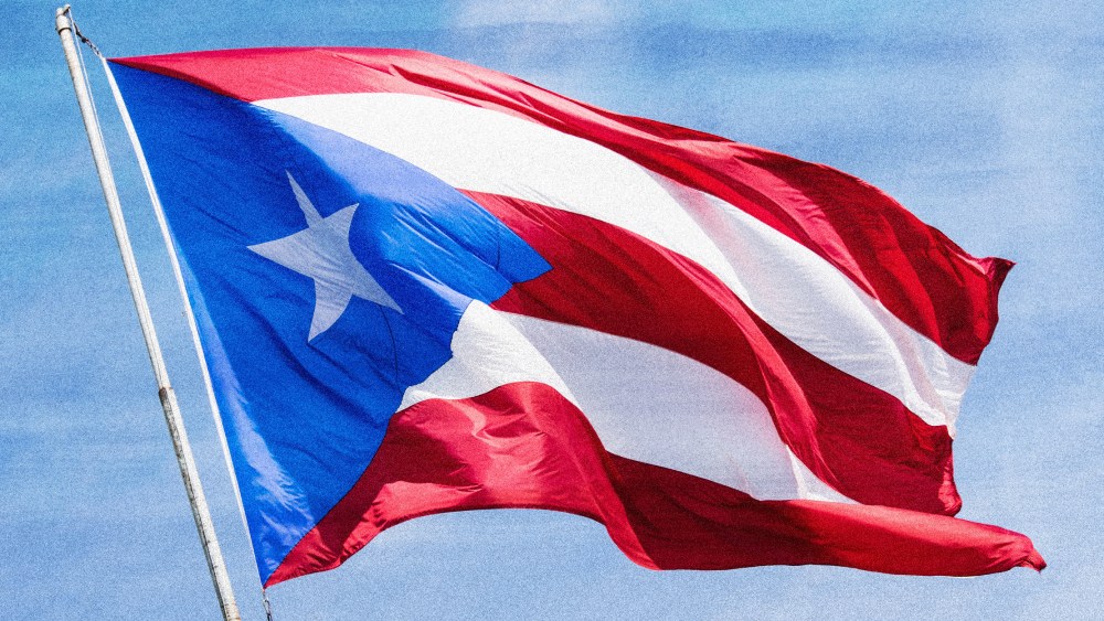 Photo illustration: A Puerto Rican flag waving in the sky.
