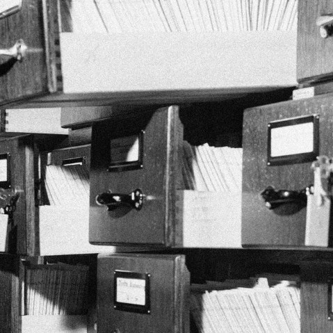 Image of stacks of open filing cabinets with papers.