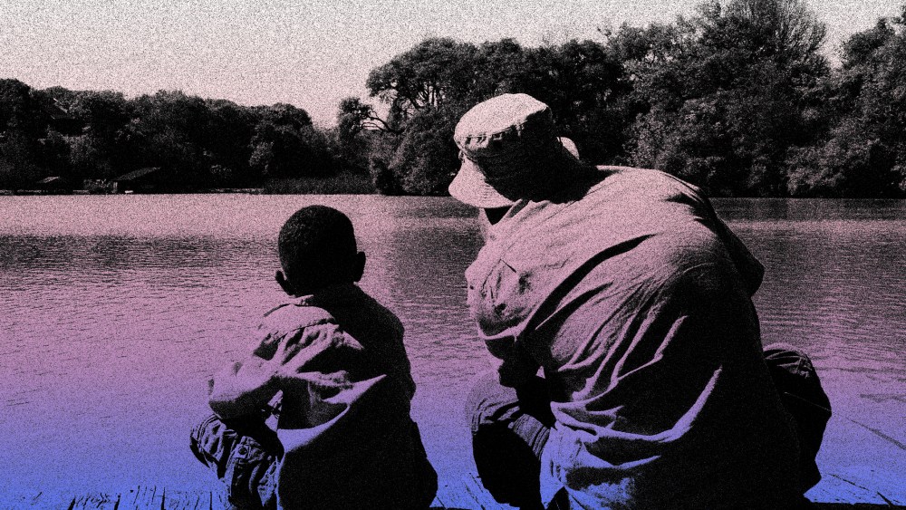Image: Father and son looking at a lake.