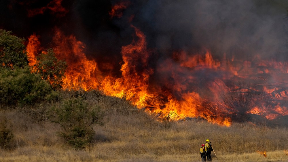 Image: Firefighters battle brush fire burning in the Santa Fe Dam Recreation Area, in Irwindle, California.