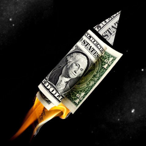 Photo illustration: A space rocket made of dollar bills.