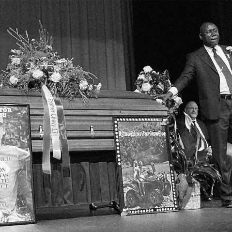 Image: Attorney Ben Crump stands next to Hunter Brittain's casket at his memorial service.